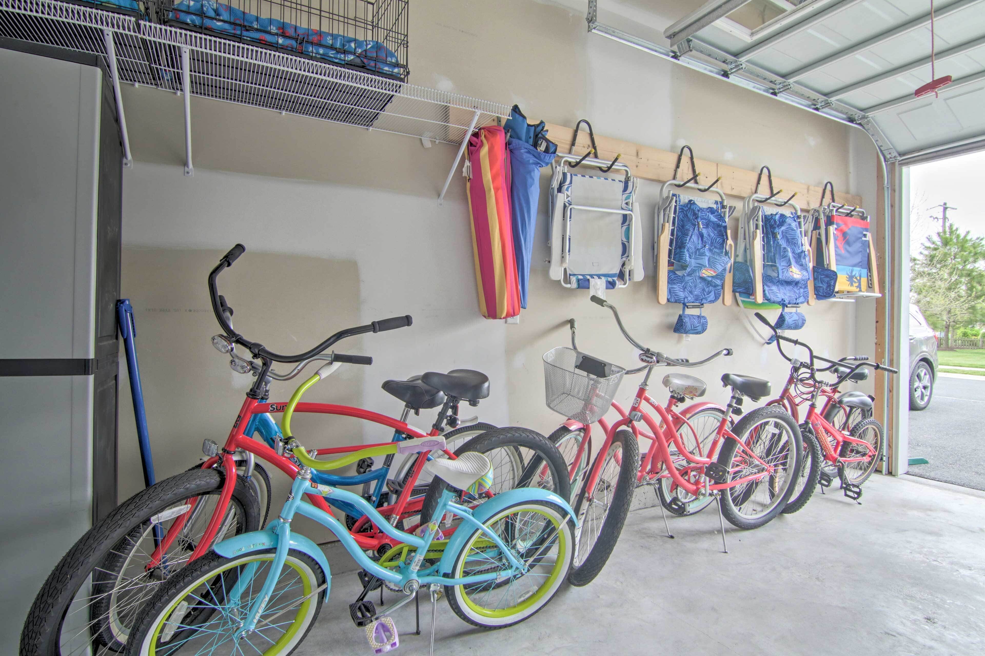 Bicycles parked inside a garage with a metal rack and a wall-mounted bike rack.