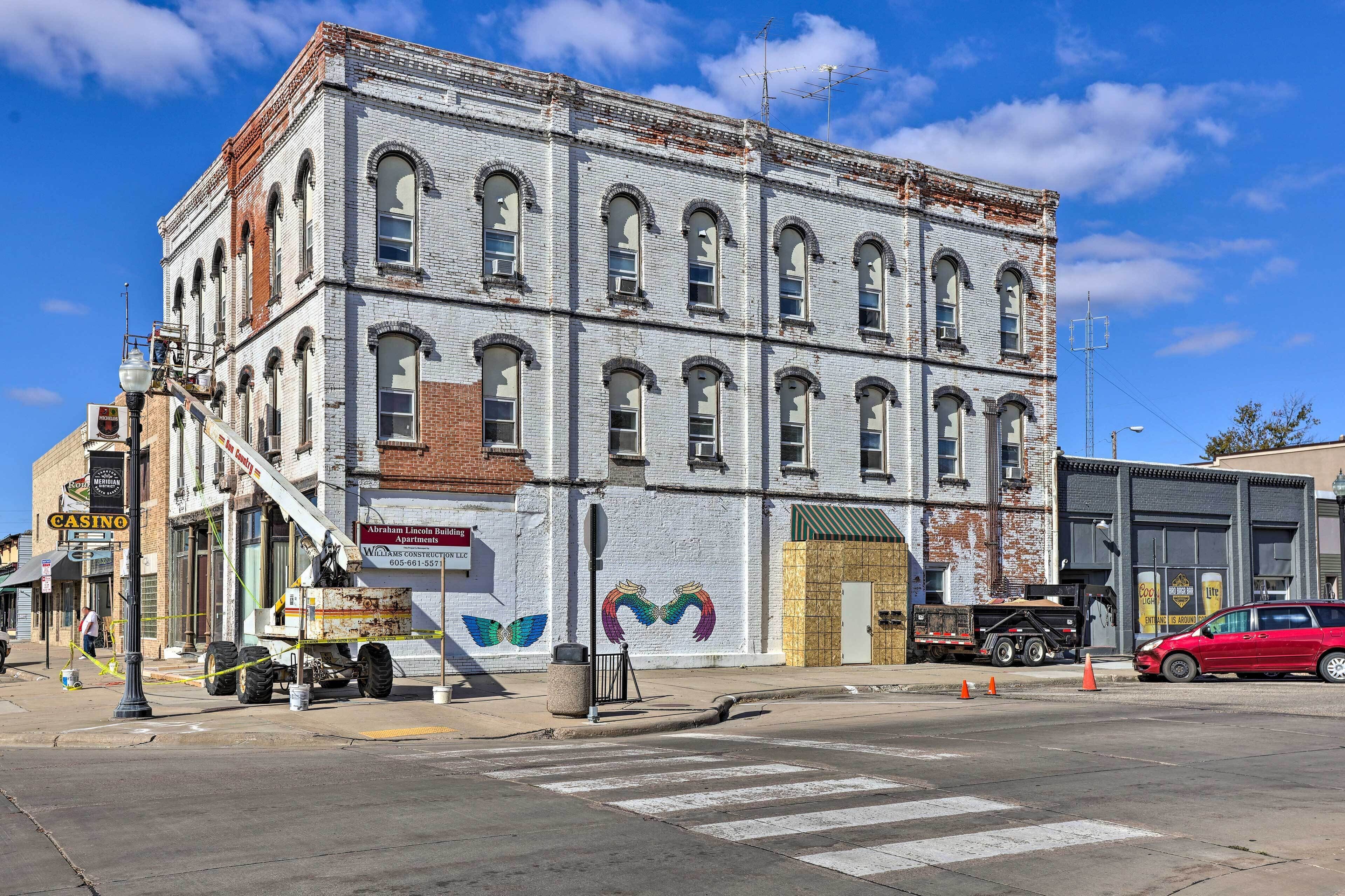 A multi-story building with a brick facade and large windows.