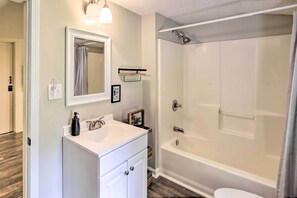 A bathroom with a white sink, mirror, and bathtub. - Private Riverfront Escape w/ Fire Pit & Grill (Saltville)
