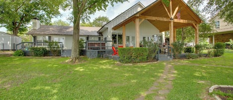 A house with a covered porch, a pathway leading to the front door, and a well-maintained lawn.