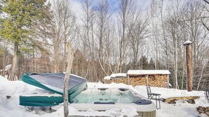 A hot tub partially covered in snow, surrounded by a wooden deck and a stack of firewood. - 4 Mi to Sugarbush Resort: Waitsfield Retreat (Waitsfield)