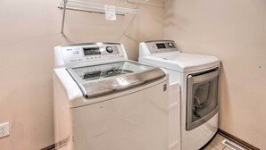 A laundry room with two washing machines and a drying rack. - Pet-friendly Des Moines Home w/ Fenced Yard! (Des Moines)