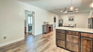 A spacious kitchen with a large island, wooden flooring, and pendant lighting. - Waterfront Retreat < 4 Mi to Dtwn Cambridge! (Cambridge)