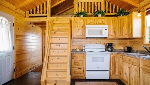 A wooden cabin kitchen with a built-in microwave, stove, and wooden cabinets. - Paradise Valley Cabin by Chico & Yellowstone Park! (Livingston)