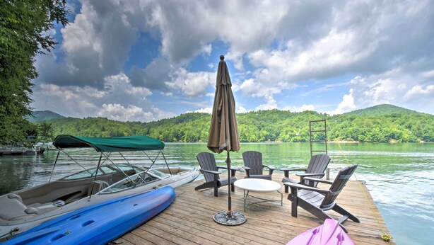 A wooden dock with a table and chairs, a covered boat, and a kayak. - Nantahala Lake Family Home w/ Private Dock & Views (Topton)