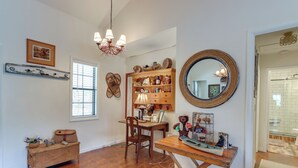 A room with a wooden desk, a chair, a bookshelf, a mirror, and a chandelier. - Nantahala Lake Family Home w/ Private Dock & Views (Topton)