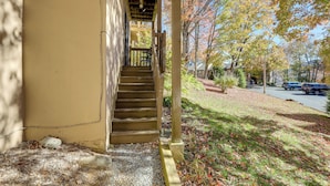 A wooden staircase leading to a porch with a view of a street and autumn trees. - 1/2 Mi to Sugar Mtn Resort: Condo w/ Balcony (Banner Elk)