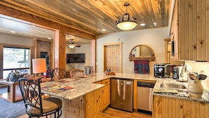 A kitchen with wooden cabinets, a stainless steel dishwasher, and a granite countertop. - Cozy Buena Vista Apartment < 4 Mi to Main Street! (Buena Vista)