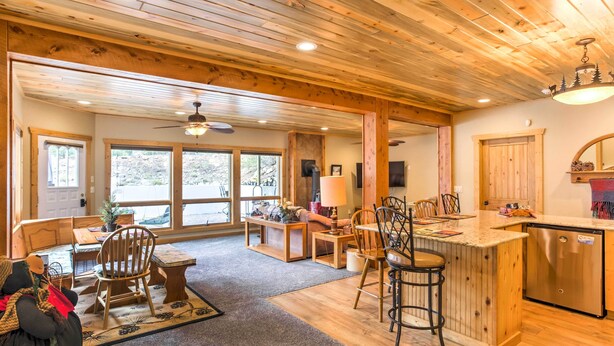 A spacious kitchen with wooden cabinetry, a central island, and a dining area with chairs and a table. - Cozy Buena Vista Apartment < 4 Mi to Main Street! (Buena Vista)