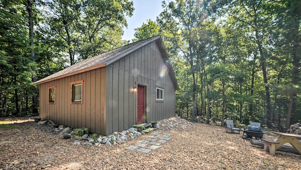 A wooden cabin with a red door, surrounded by a gravel path and trees. - Private Murray Abode w/ Fire Pit: Hunt & Fish (Murray)