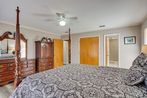 A bedroom with a four-poster bed, wooden wardrobe, and a ceiling fan. - Spacious Texas Getaway 1/2 Mi to Lake Texoma! (Pottsboro)