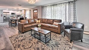 A modern living room with a sectional sofa, a coffee table, and a patterned rug. - 1 Mi to Hersheypark: Family Home w/ Game Room! (Hershey)