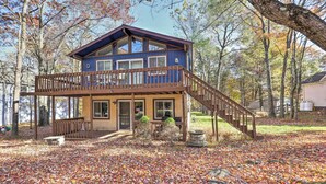A two-story house with a wooden deck and a staircase leading to the upper level. - < 7 Mi to Slopes: Inviting Pocono Mtn Retreat! (Albrightsville)
