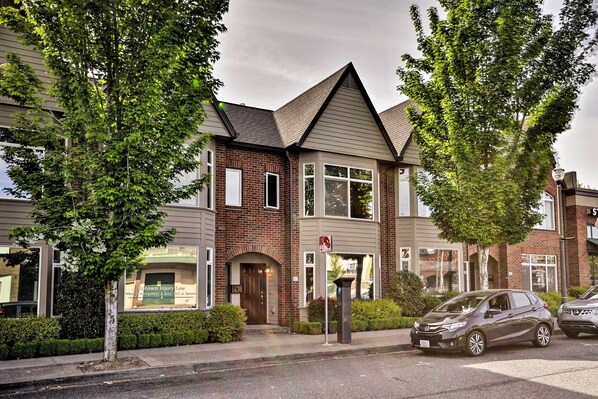 A two-story building with a brick facade, large windows, and a gated entrance. - Modern Vancouver Townhome - Right on Main St! (Vancouver)
