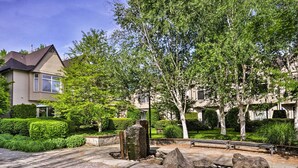 A residential area with a stone pathway, a small pond, and well-maintained greenery. - Modern Vancouver Townhome - Right on Main St! (Vancouver)