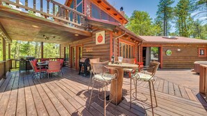 A wooden cabin with a deck, outdoor seating, and a grill area. - Deck & Hot Tub Bear Country Cabin, Upper Canyon (Ruidoso)