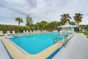 A swimming pool with lounge chairs and a small pavilion. - 4 Mi to Beach: Pet-friendly Home in Naples! (Naples)