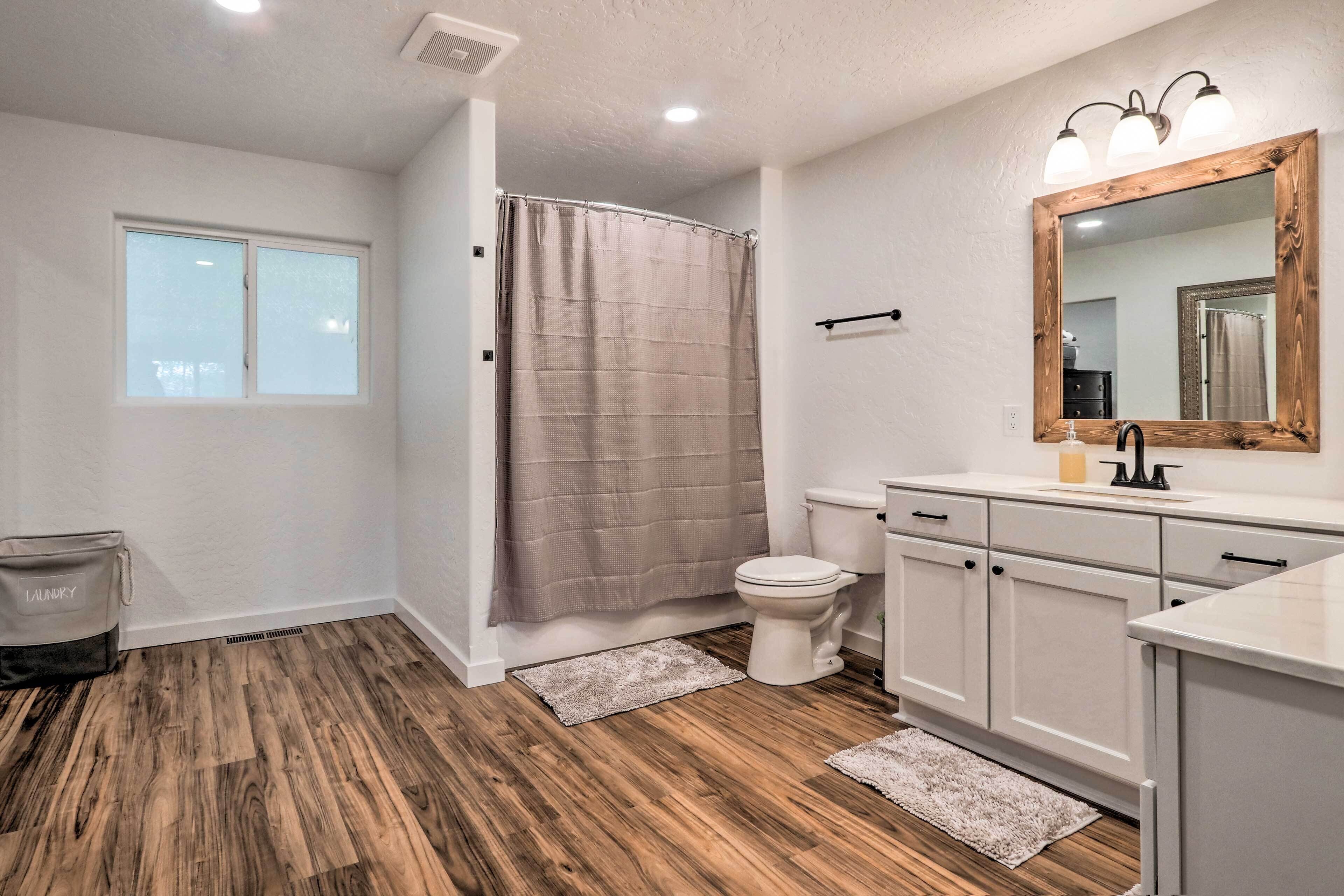 A bathroom with a shower, toilet, and sink.