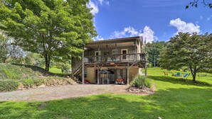 A two-story house with a balcony, a covered porch, and a front door. - Deep Gap Cottage w/ Fire Pits - Hike & Ski! (Deep Gap)