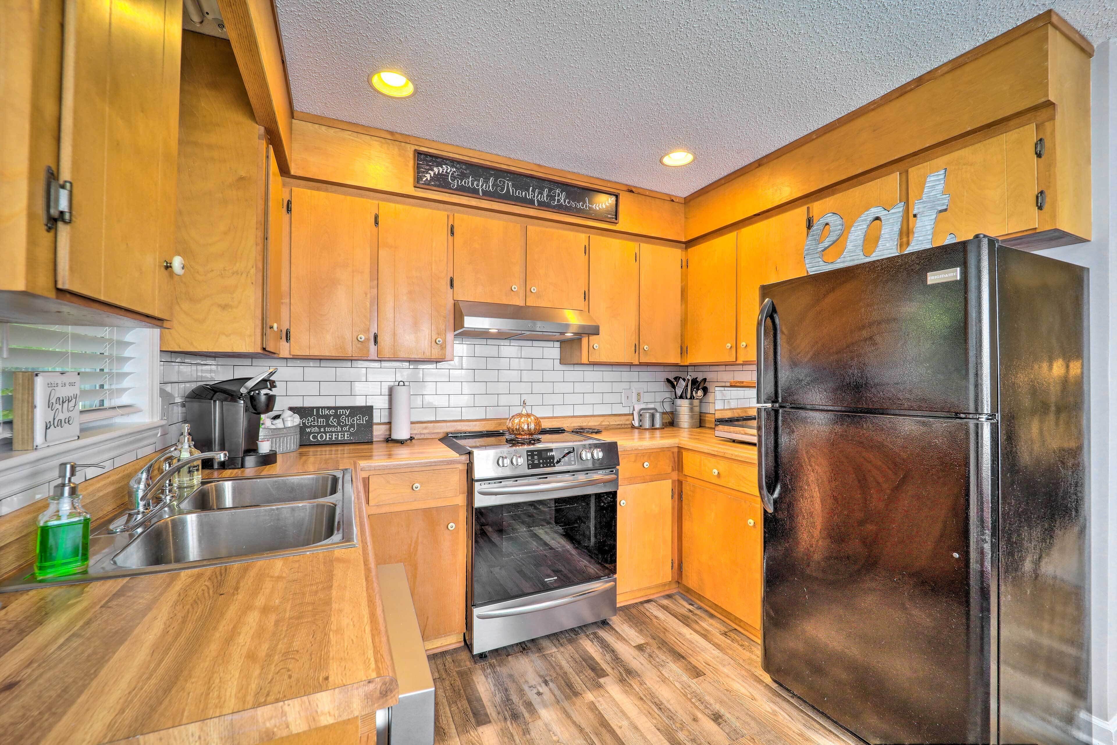 A kitchen with wooden cabinets, stainless steel appliances, and a sign that says "eat."