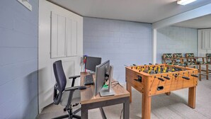 A room with a foosball table, a computer desk with a monitor and keyboard, and several chairs. - Deep Gap Cottage w/ Fire Pits - Hike & Ski! (Deep Gap)