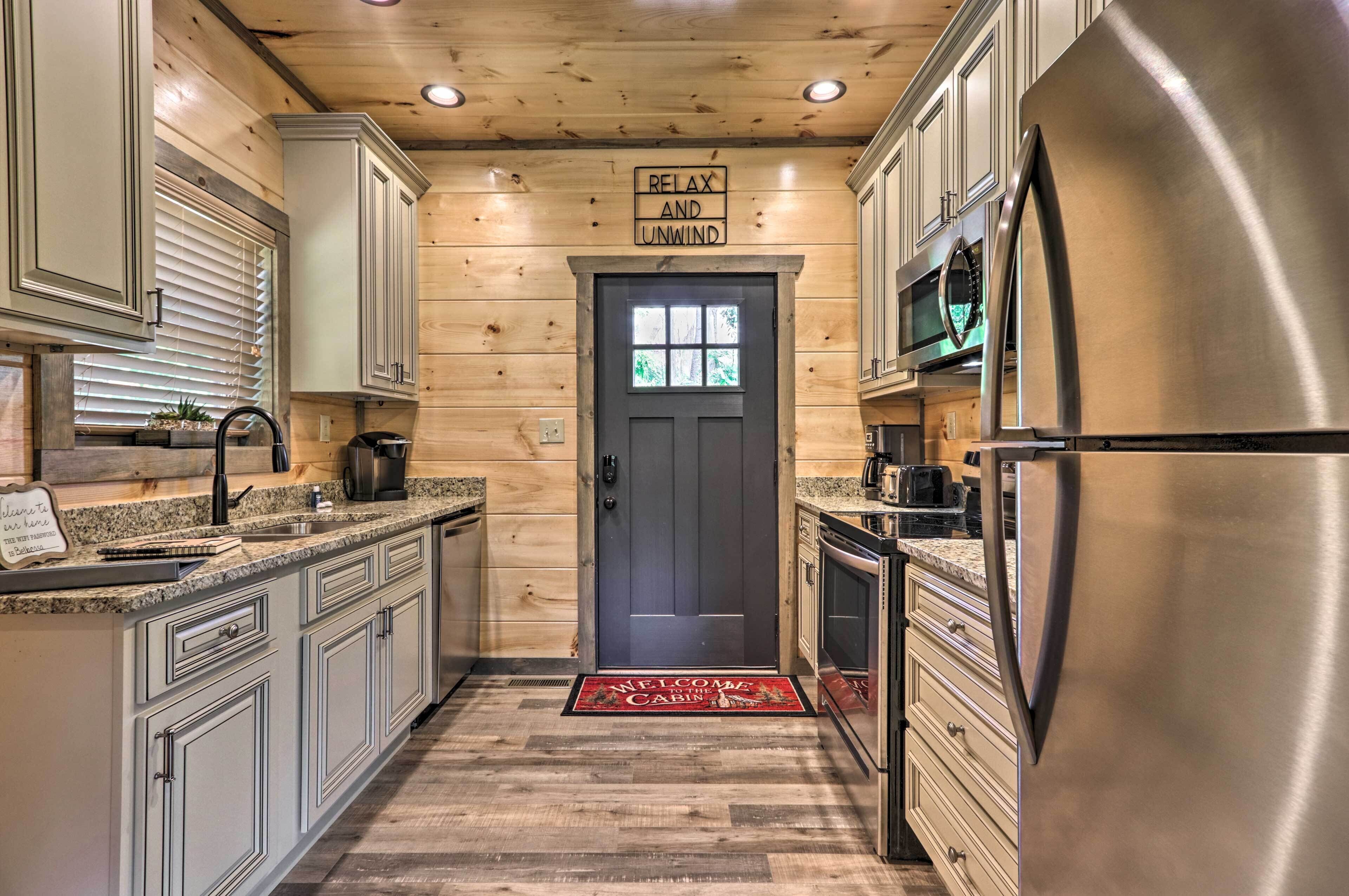 A kitchen with wooden walls, a stainless steel refrigerator, and a microwave.