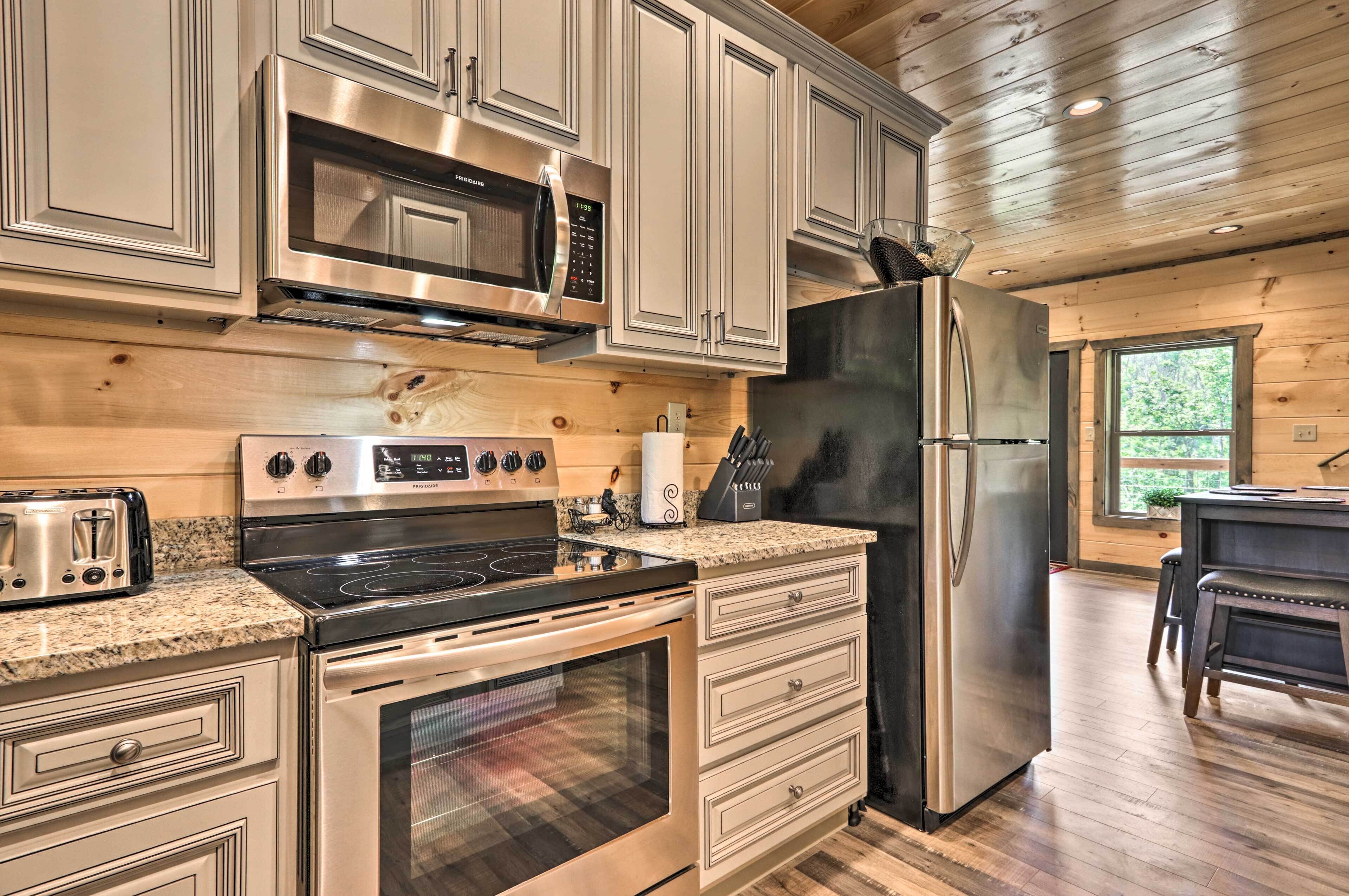 A modern kitchen with stainless steel appliances, wooden cabinets, and a granite countertop.