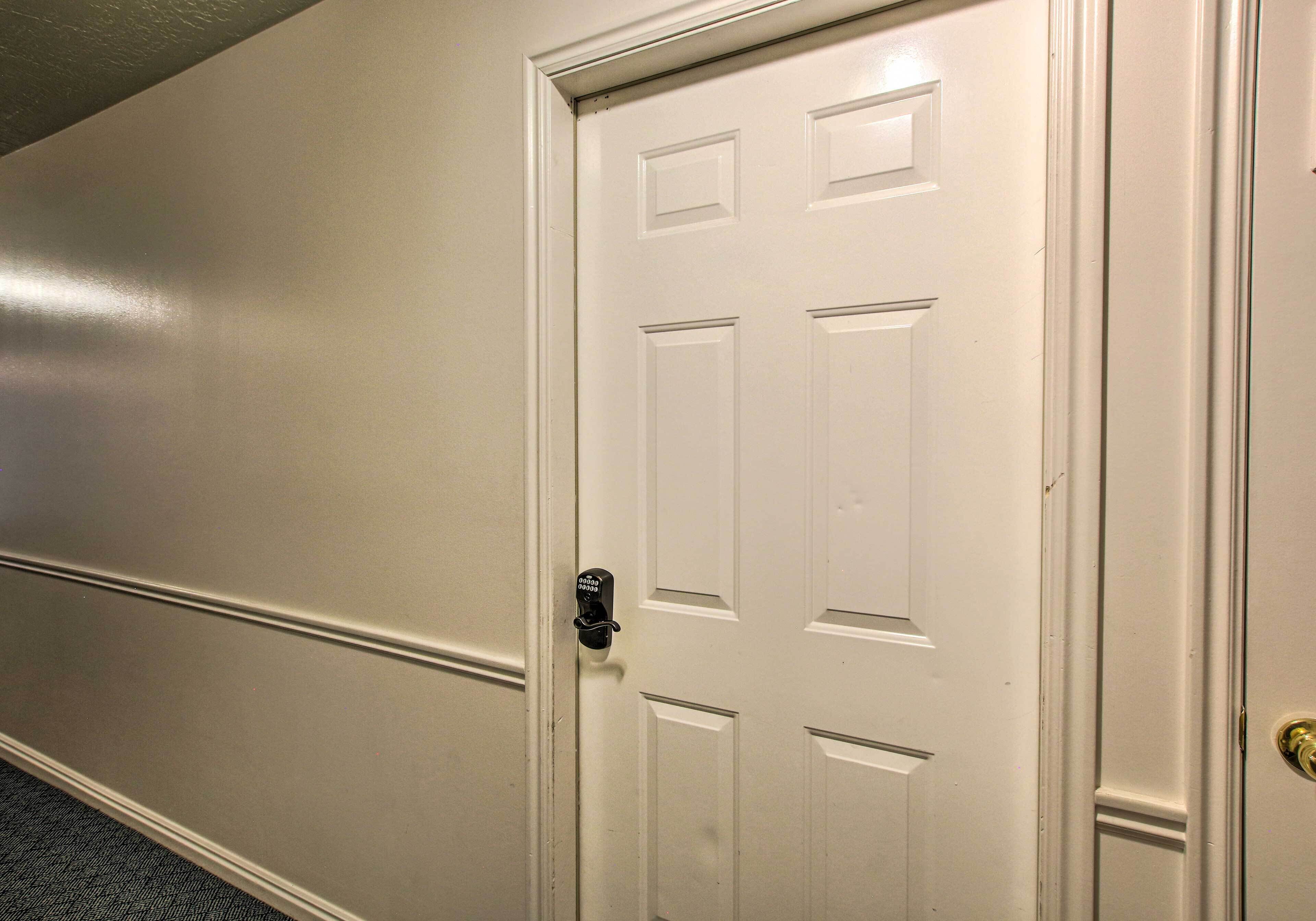 A white door with a keyhole and a doorbell.