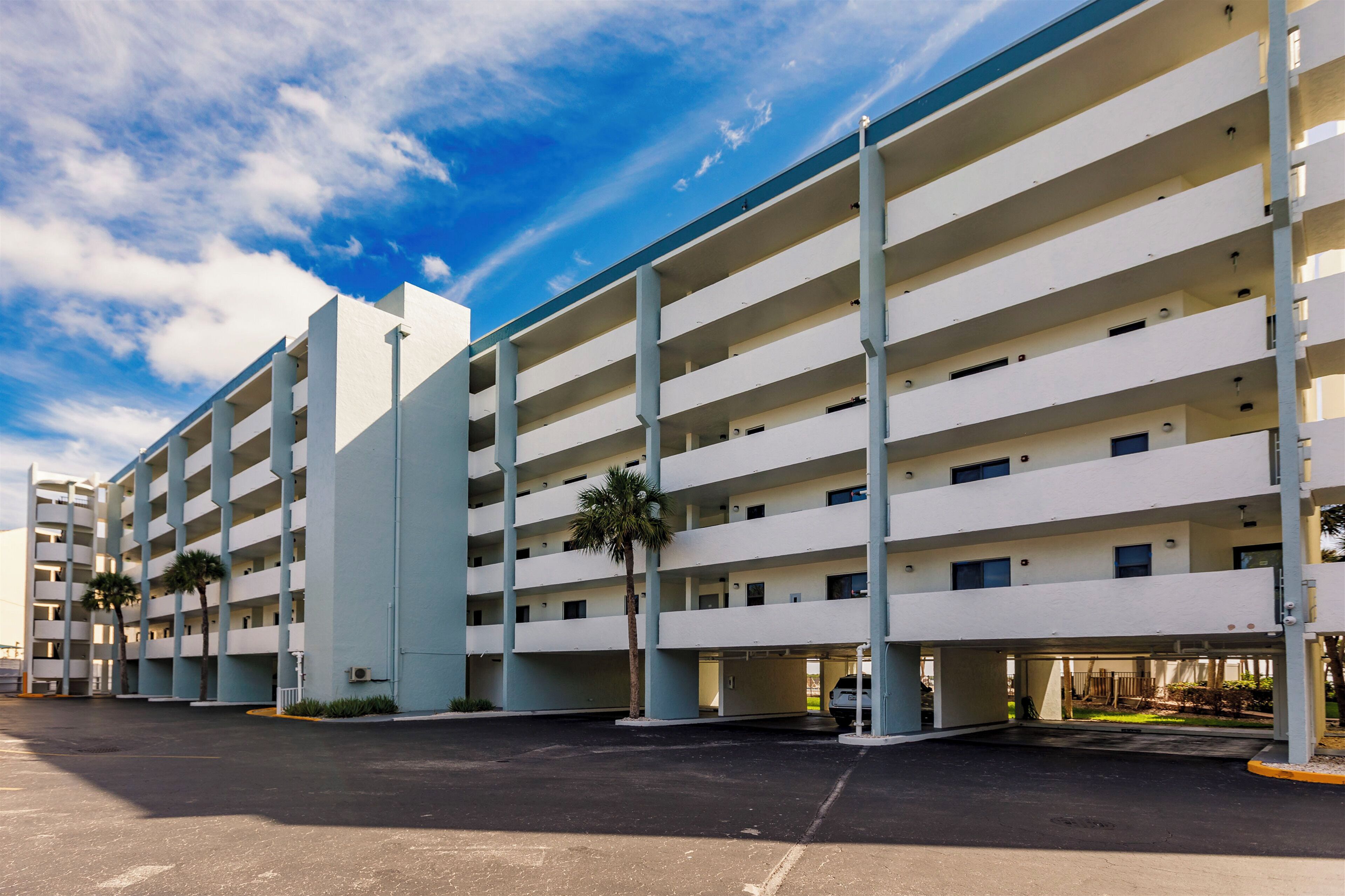 A multi-story parking garage with a clear sky.