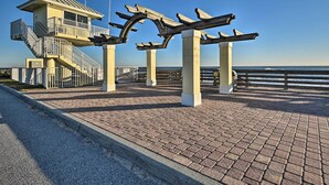 A lifeguard tower and wooden benches on a paved walkway by the beach. - Pet-friendly Ormond Beach Home w/ Fire Pit! (Ormond Beach)
