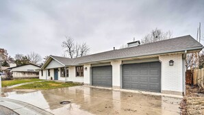A residential house with a garage, a driveway, and a lawn. - Pet-friendly Caldwell Home Rental Near Lake! (Caldwell)