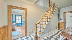 A staircase with wooden balusters and a checkered floor. - Rustic & Historic Guildhall Farmhouse w/ Fire Pit! (Guildhall)