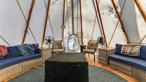 A cozy interior with a sofa, chairs, a fan, and a ladder against a textured wall. - Kingston Home w/ Pickleball: Steps to Lake Texoma! (Kingston)