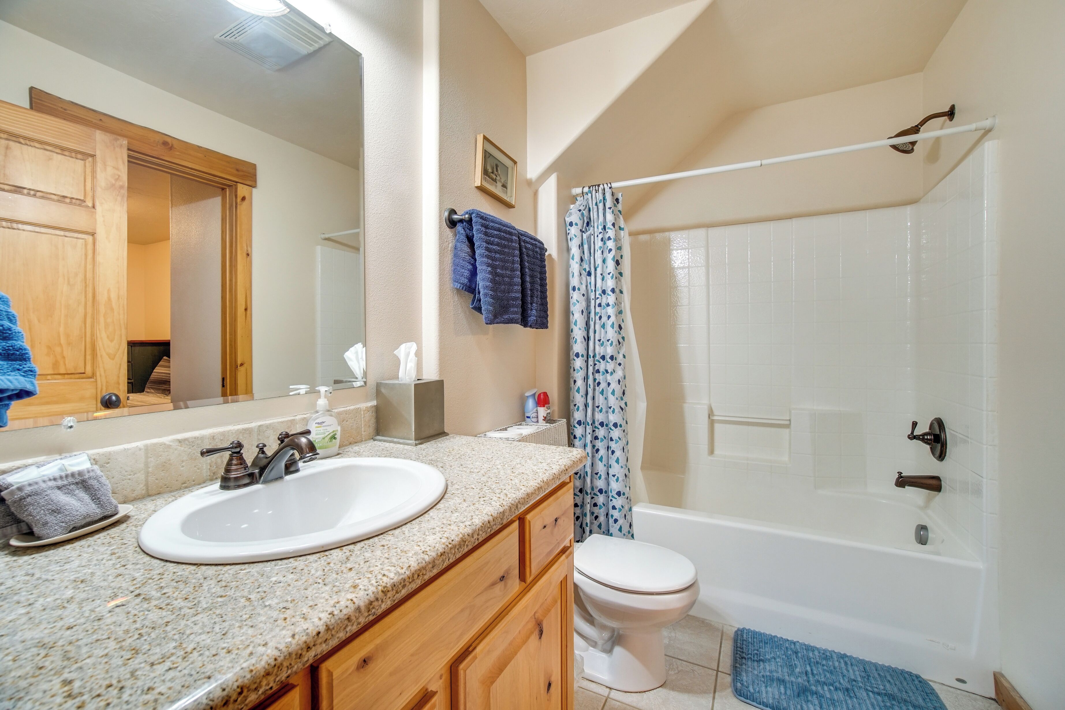 A bathroom with a sink, toilet, and bathtub.