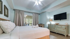 A bedroom with a bed, a dresser, a television, and a ceiling fan. - Golf Course Home w/ Balcony in North Myrtle Beach! (North Myrtle Beach)