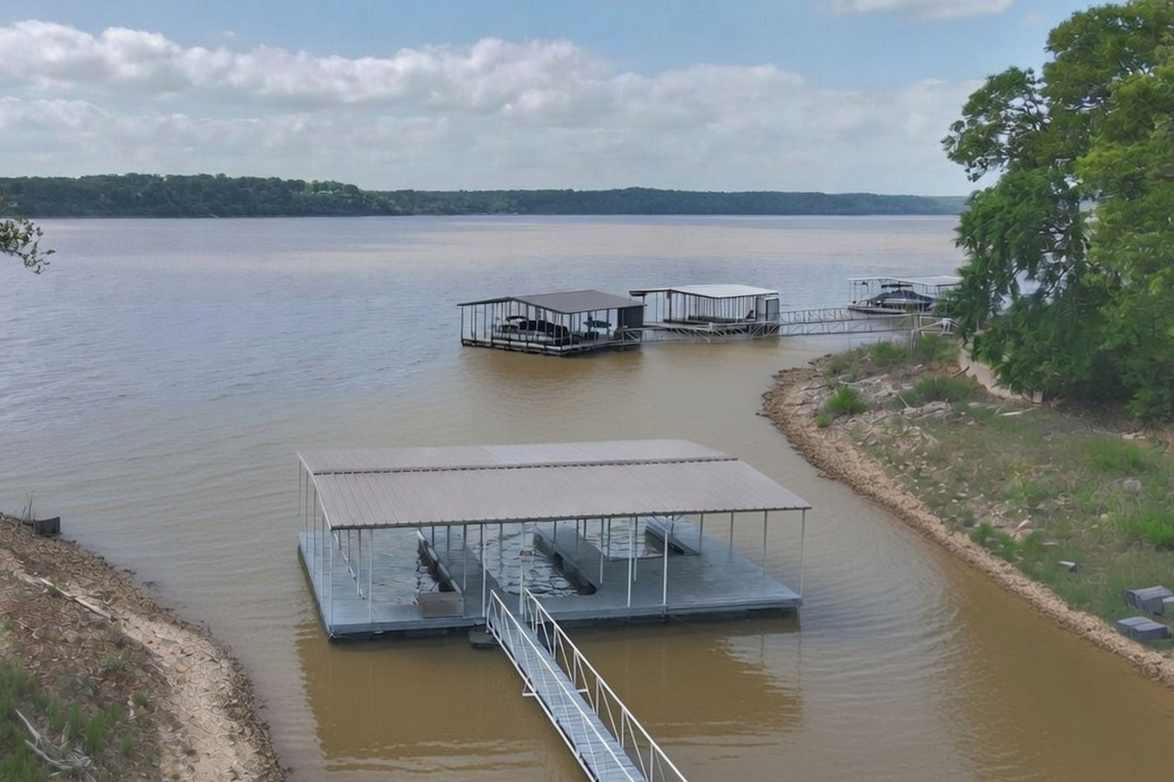 A lake with floating docks and a covered boat launch area.