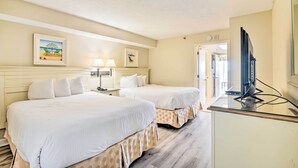 A hotel room with two beds, a TV, and artwork on the wall. - Oceanfront Myrtle Beach Condo w/ Balcony! (Myrtle Beach)