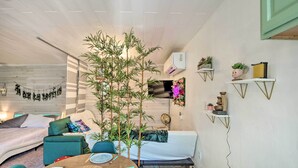 A compact living space with a bed, a dining table with chairs, a sofa, and a small kitchen area. - 'the Goat Hut' Studio Casita: 11 Mi to Strip! (Las Vegas)