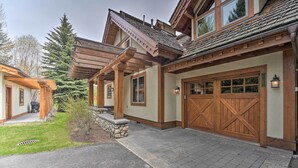A modern house with a large garage, stone steps, and a covered porch. - Serene Sun Valley Home w/ Hot Tub & Mtn Views (Sun Valley)
