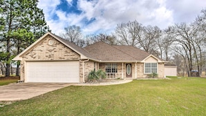 A single-story house with a brick facade, a garage, and a front lawn. - Family Alba Home w/ Boat Dock on Lake Fork! (Alba)