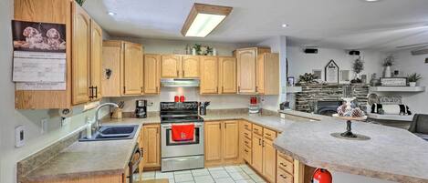 A modern kitchen with wooden cabinets, a stainless steel stove, and a built-in oven.