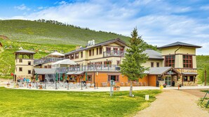 A hotel with multiple buildings, outdoor seating, and a dirt path leading to the entrance. - Ski-in/ski-out Granby Penthouse w/ Mountain Views! (Granby)