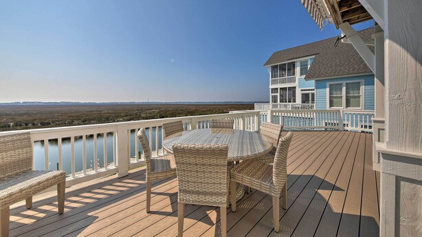 A wooden deck with wicker furniture and a view of the ocean. - Manteo Waterfront Resort Home w/ 30-ft Dock! (Manteo)