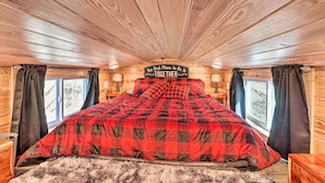 A cozy bedroom with a checkered bedspread, wooden ceiling, and a sign that reads "The Best Place To Be Together." - La Petite Maison in Mount Olive w/ Fire Pit! (Mountain View)