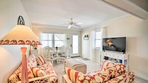 A living room with a sofa set, a television, a ceiling fan, and a dining area with a table and chairs. - Walk to Wildwood Beach: Oceanfront Condo w/ View (Wildwood Crest)