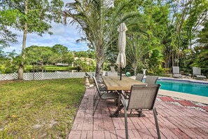 Relax by the pool surrounded by lush greenery and enjoy meals at the outdoor patio.