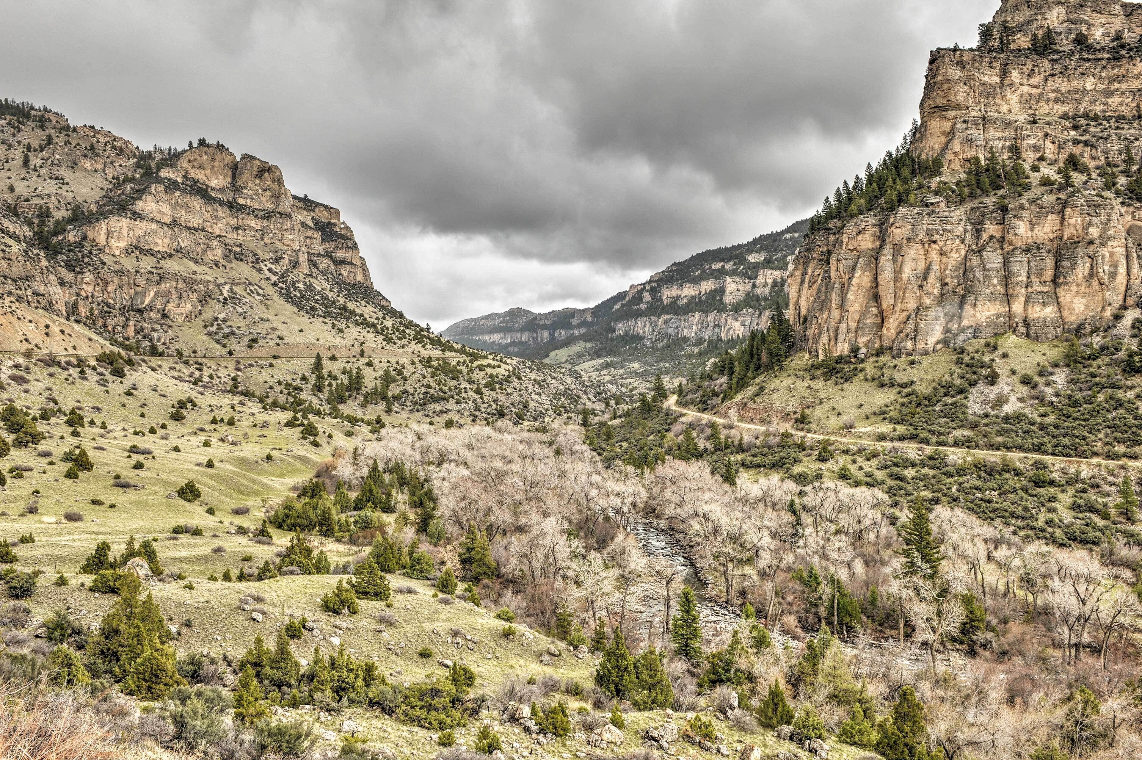 A mountainous landscape with a winding road and sparse vegetation.