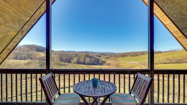 A wooden deck with a table and two chairs, overlooking a scenic landscape. - Decks, Panoramic Views! Mtn Retreat in Sparta (Sparta)