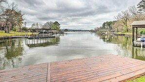 A calm lake with wooden docks and a gazebo.