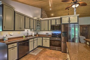 A kitchen with light green cabinets, stainless steel appliances, and a granite countertop. - Game Room, Theater + Deck: Burnsville Cabin! (Burnsville)